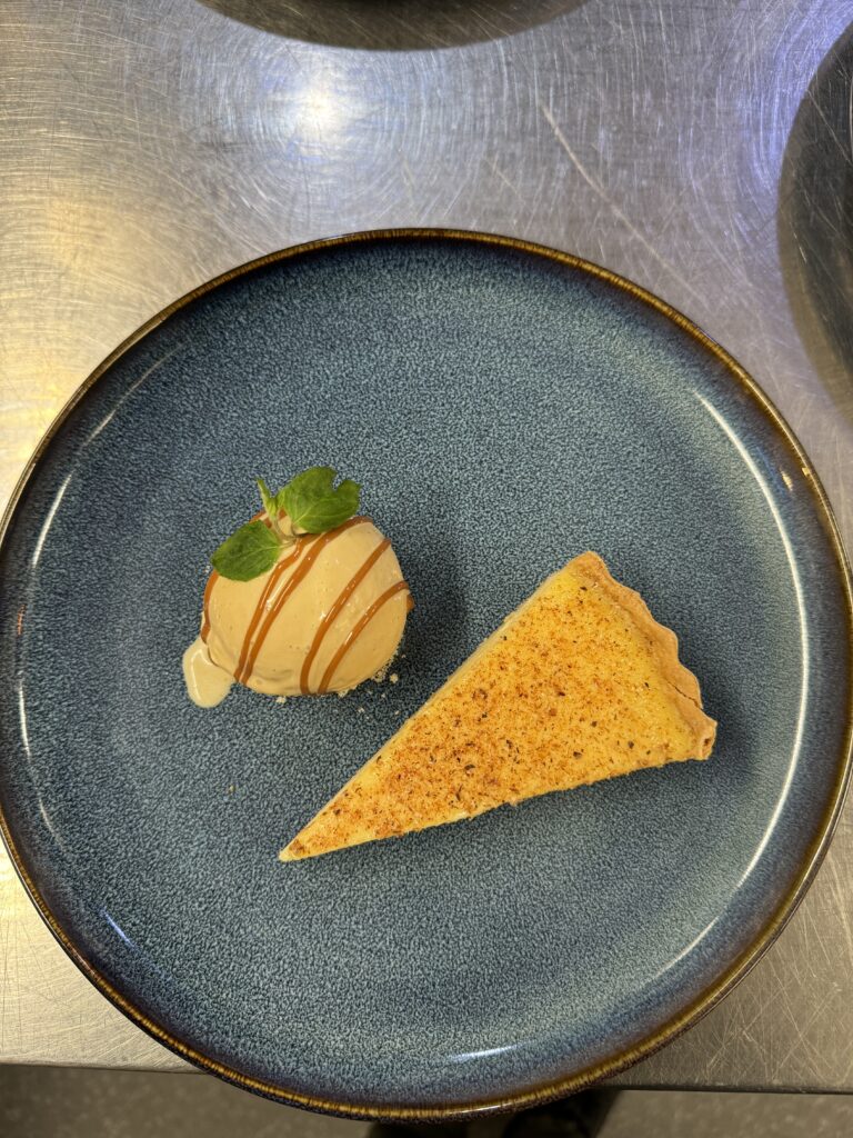 Custard tart with homemade caramel ice cream and drizzle- care catering dish